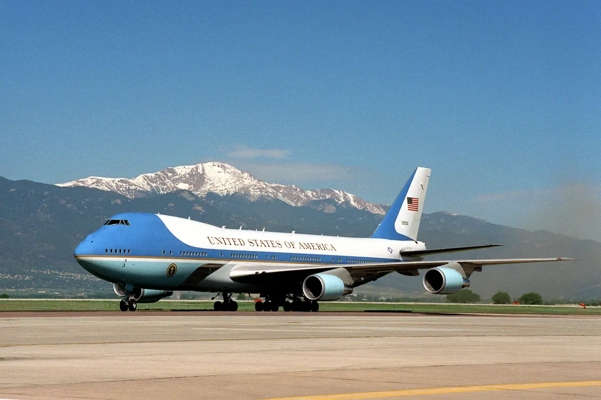 Boeing VC-25 Air Force One parked on the tarmac with mountains in the background (file photo)