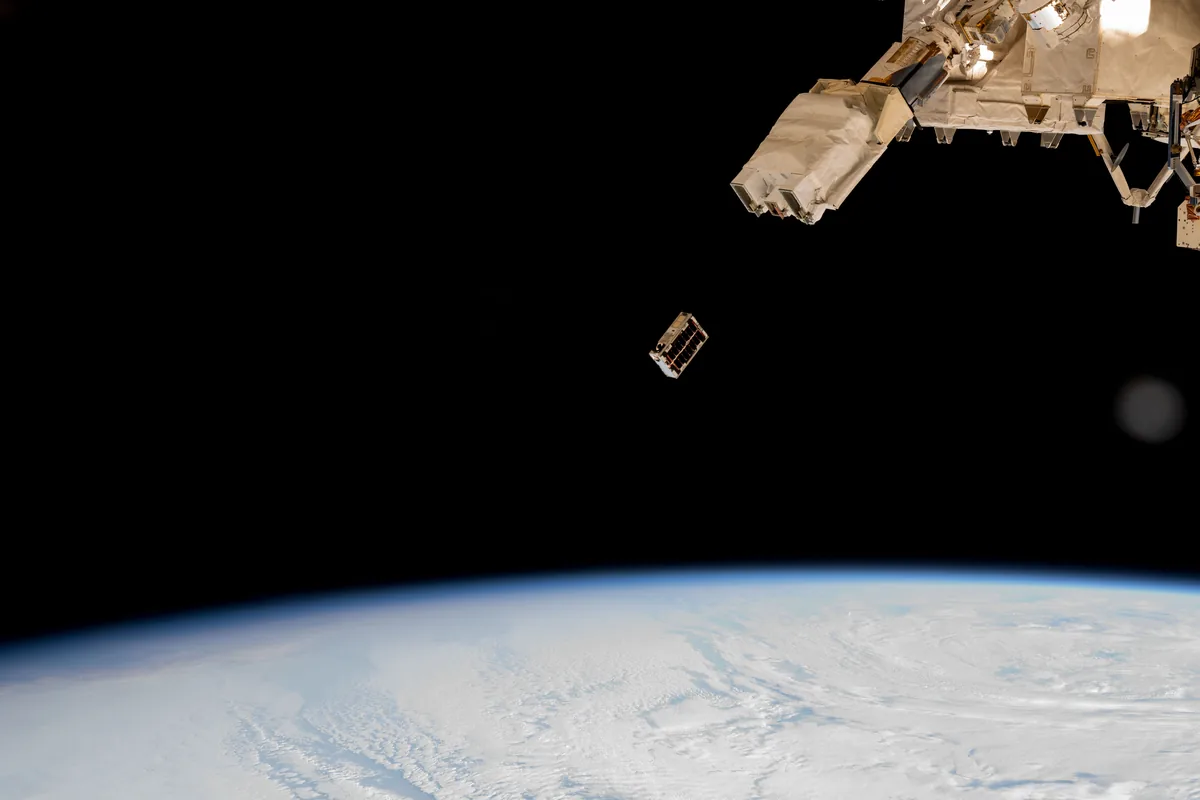 A CubeSat ejected into Earth orbit from an ISS small-satellite deployer (file photo)