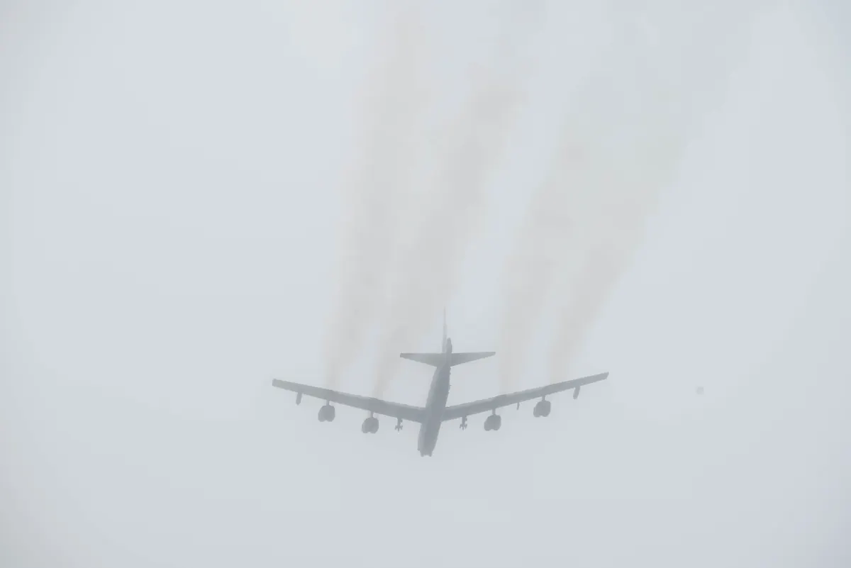 A U.S. Air Force B-52 Stratofortress takes off into thick cloud from RAF Fairford, England