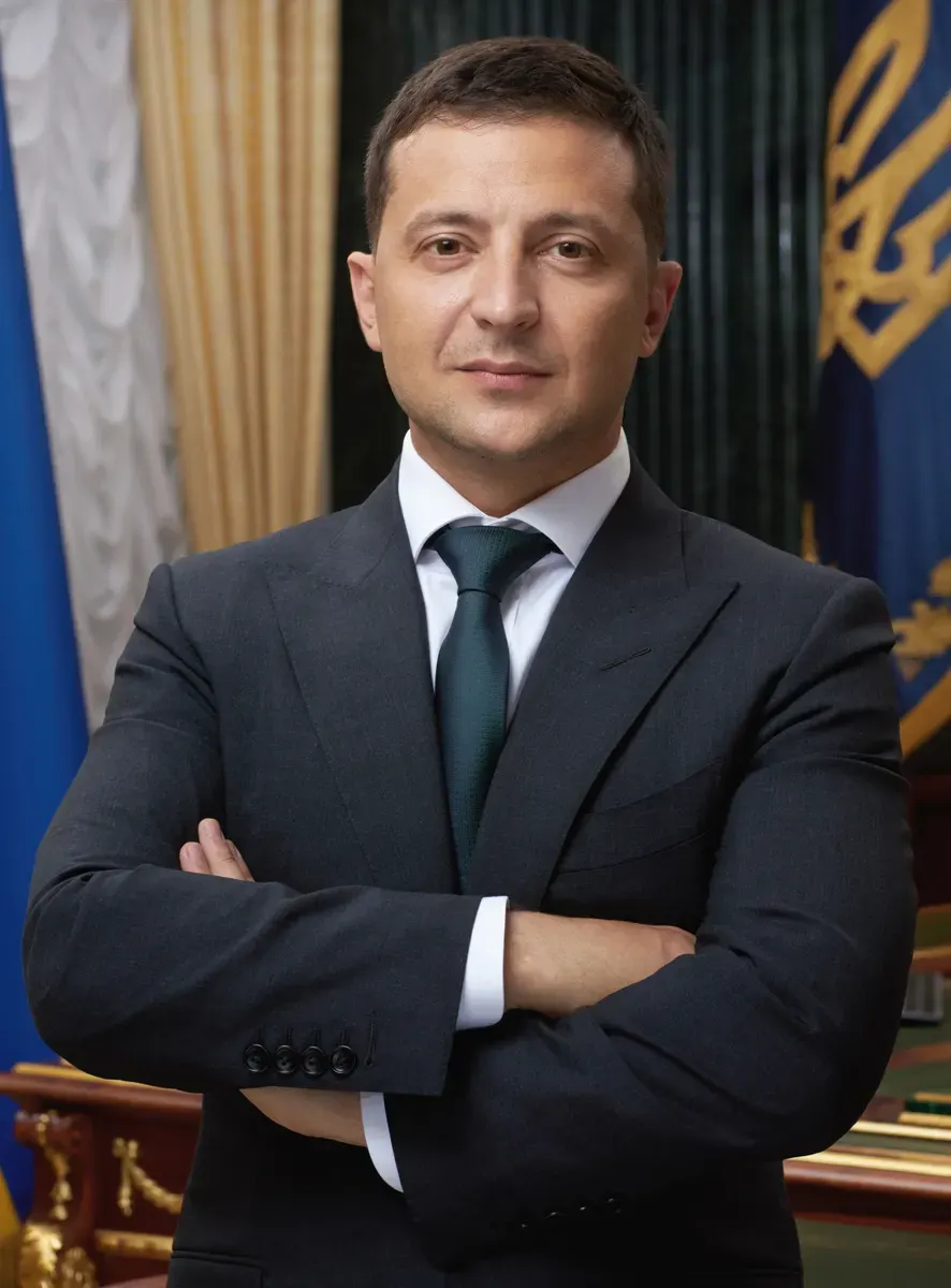 Official portrait of Ukrainian President Volodymyr Zelenskyy in a dark suit and tie
